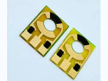 View 2: Two rectangular carbon contact PCBs showing circular interface patterns and black contact regions