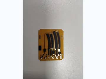 View 1: Carbon ink jumper PCB with several curved black printed paths, gold-colored pads, and terminal holes