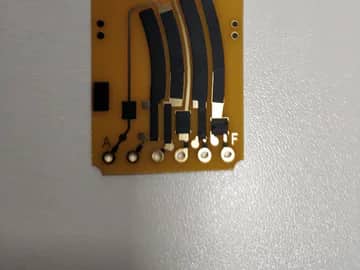 View 5: Controlled close view of a carbon ink jumper PCB showing printed paths, overlaps, and terminal pads