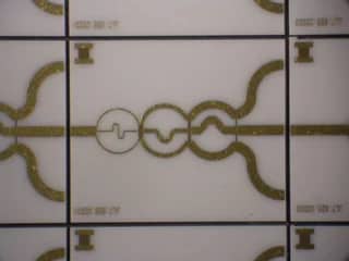 View 3: Company thin film circuit panel with connected curved patterns on a light substrate
