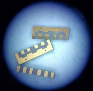View 5: Three company thin film strip samples showing contact pads, stepped patterns and circular openings