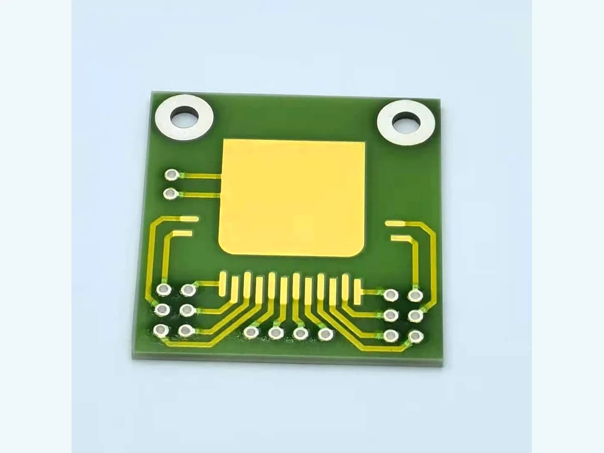 Real AlN circuit front face with visible gold-colored conductor pattern and pad regions