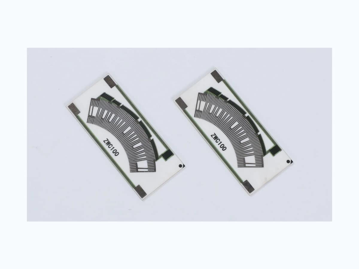 Two complete accelerator pedal position sensor resistor cards with printed arc tracks