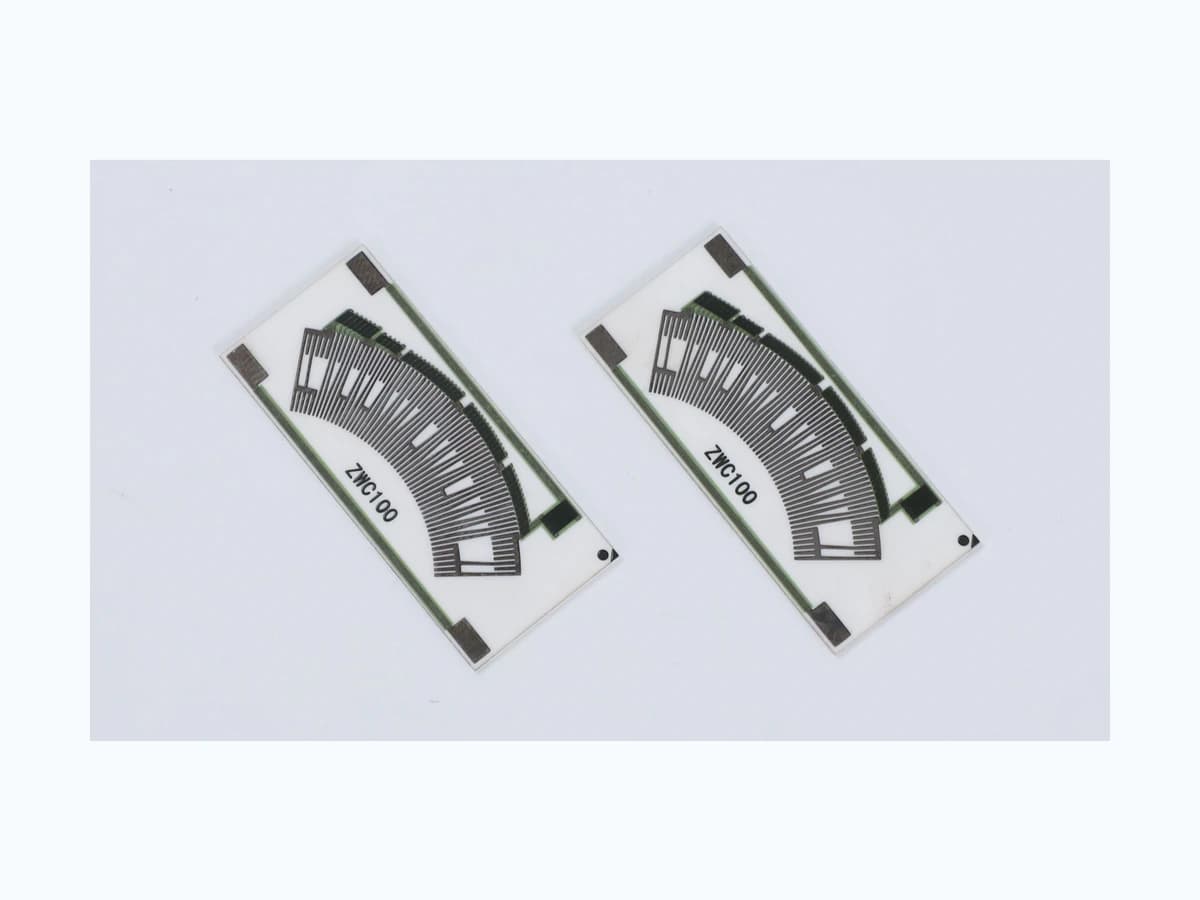 Real product photograph of accelerator pedal position sensor resistor cards with visible curved tracks