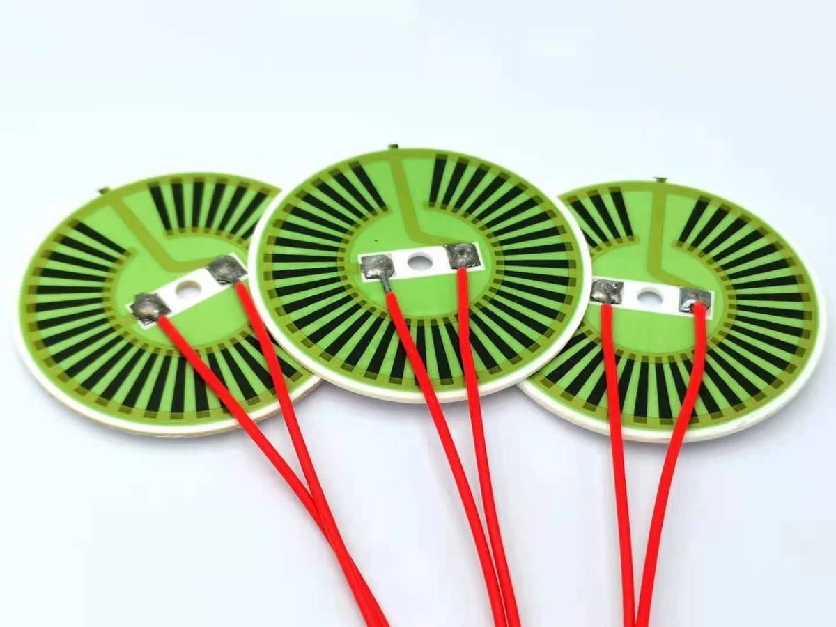 Real alumina thick film heater discs with attached lead wires and printed radial heater tracks
