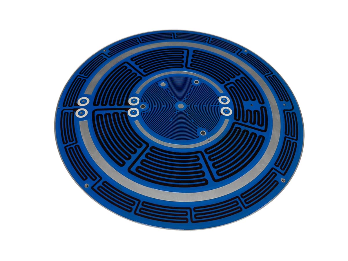 Circular aluminum substrate heater showing visible metal edge, printed surface, holes, and pads