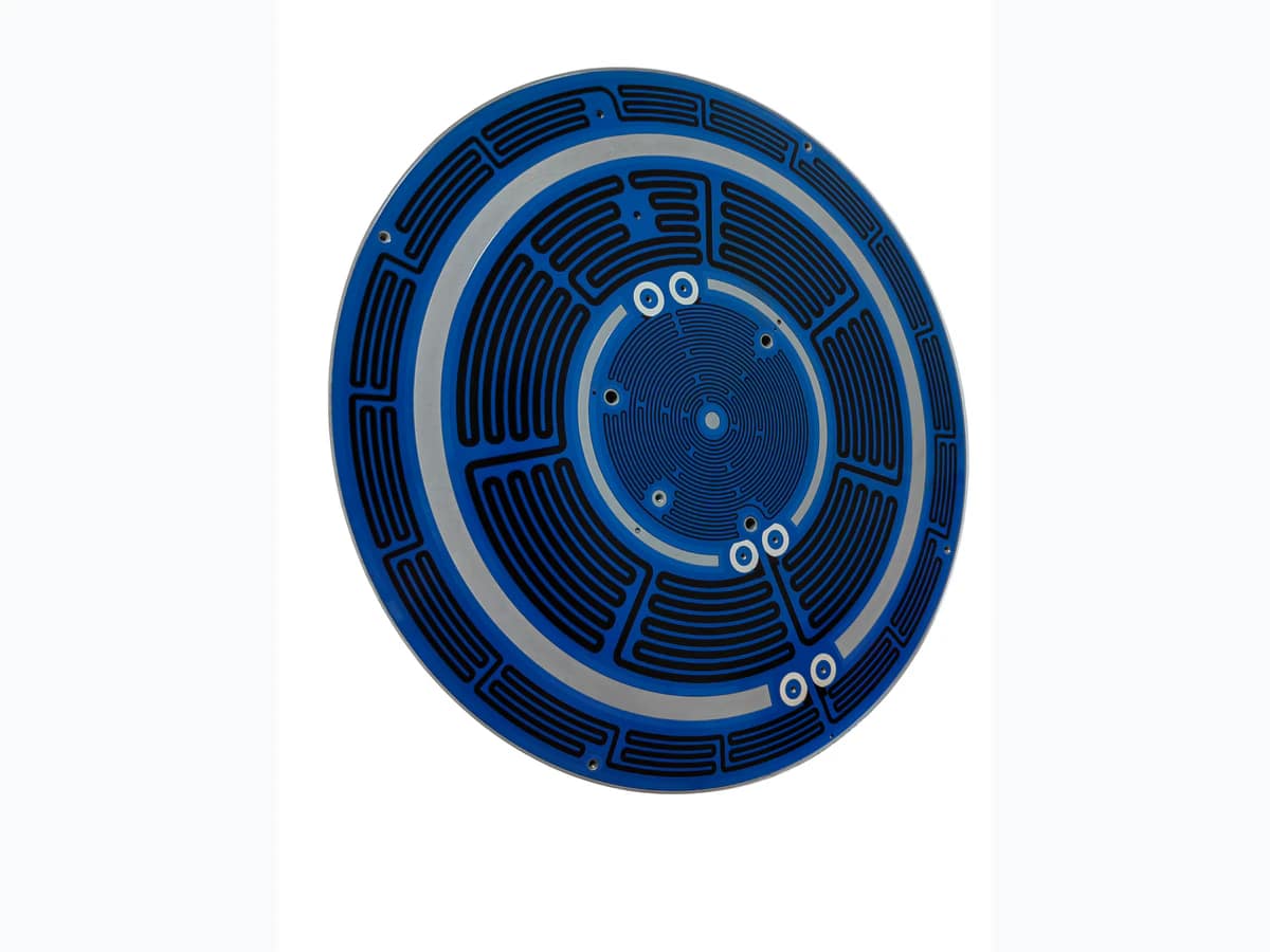 Supplied aluminum substrate heater photograph showing a circular printed layout and mounting features