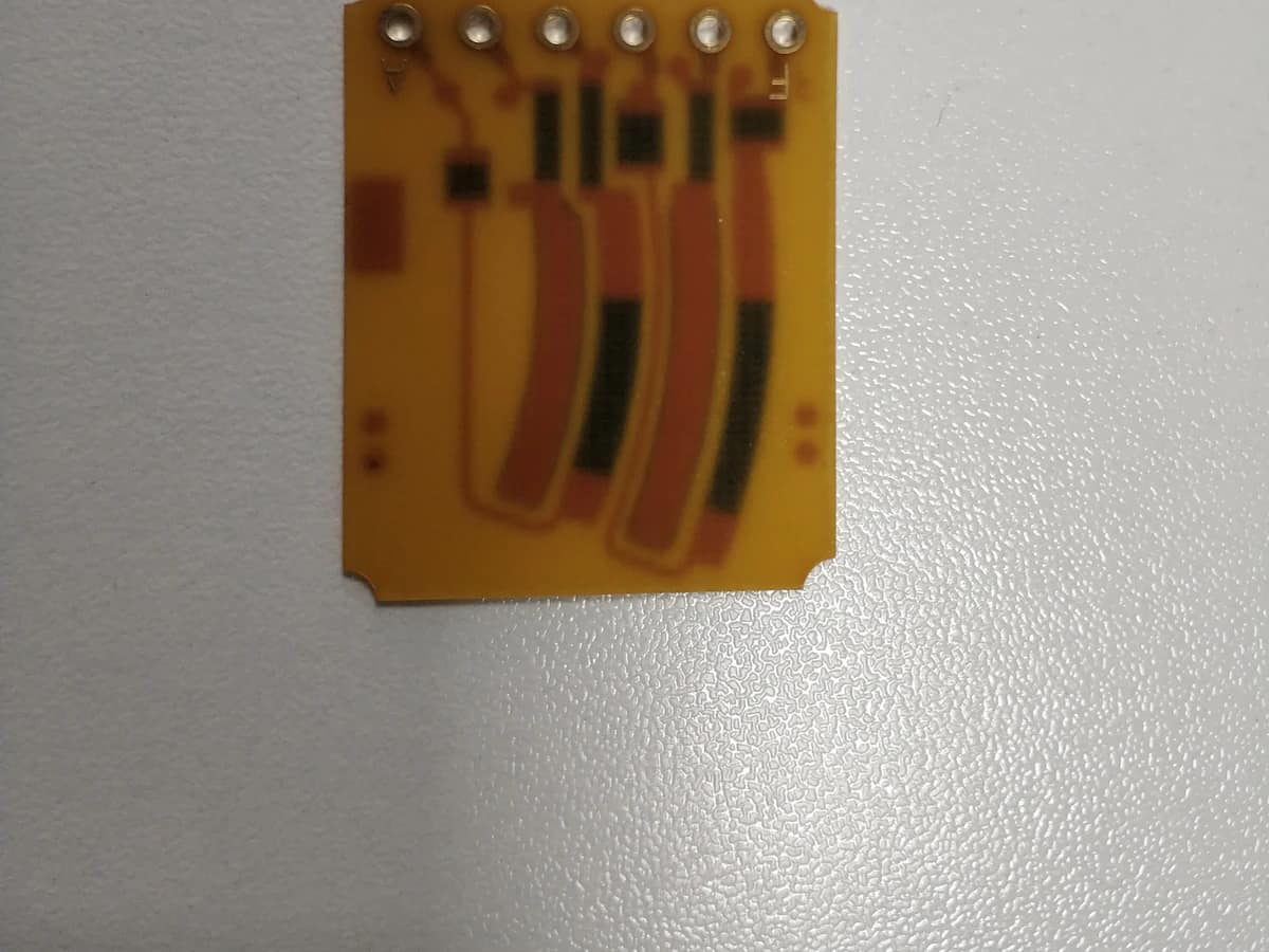 Controlled detail crop of a verified carbon ink jumper PCB showing black printed paths and conductor overlaps