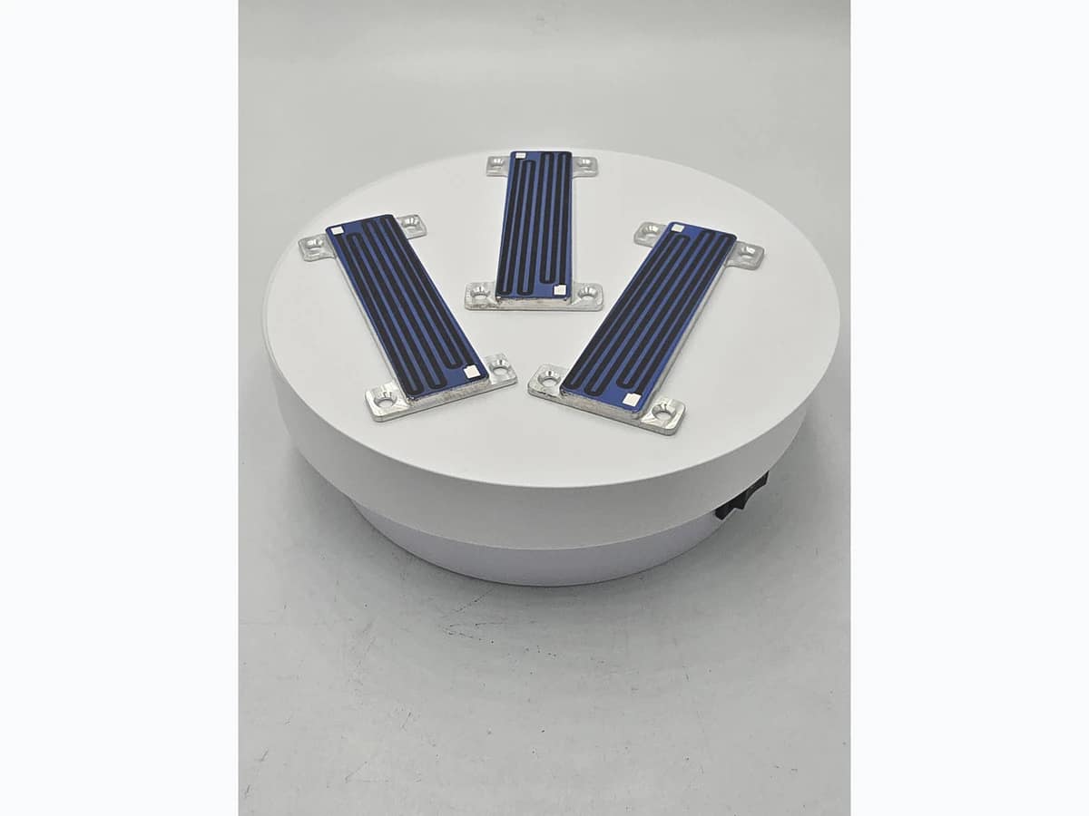 Group of compact heater modules showing visible outlines, mounting ears, holes, and printed surfaces
