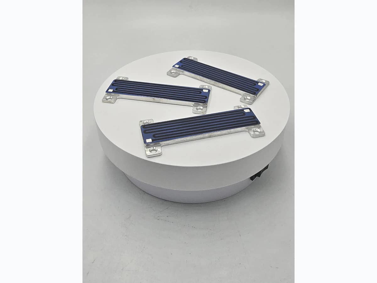 Supplied angled photograph of compact custom heater modules with visible printed paths and mounting features