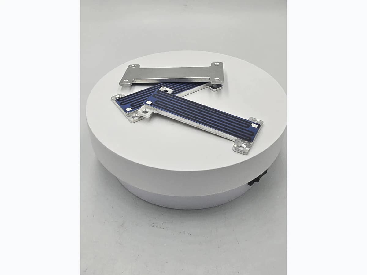 Supplied rear and edge photograph of compact custom-shaped heater modules
