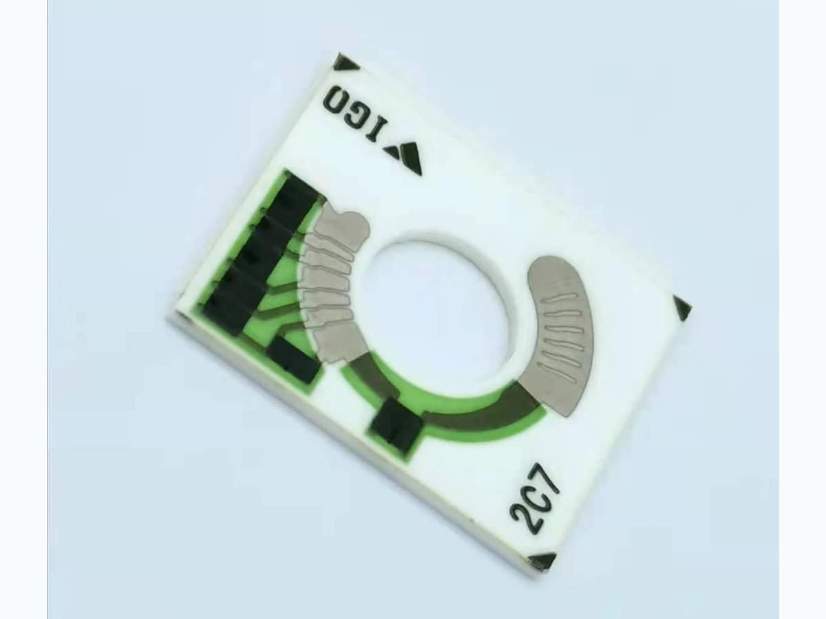 Verified complete motorcycle fuel gauge resistor card with central opening and printed arc tracks