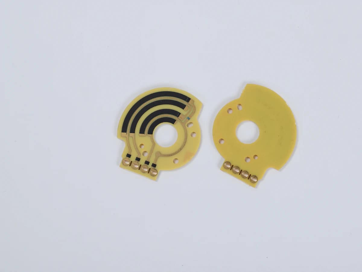Controlled detail crop of a verified rotary carbon film sensor PCB showing concentric tracks and terminals