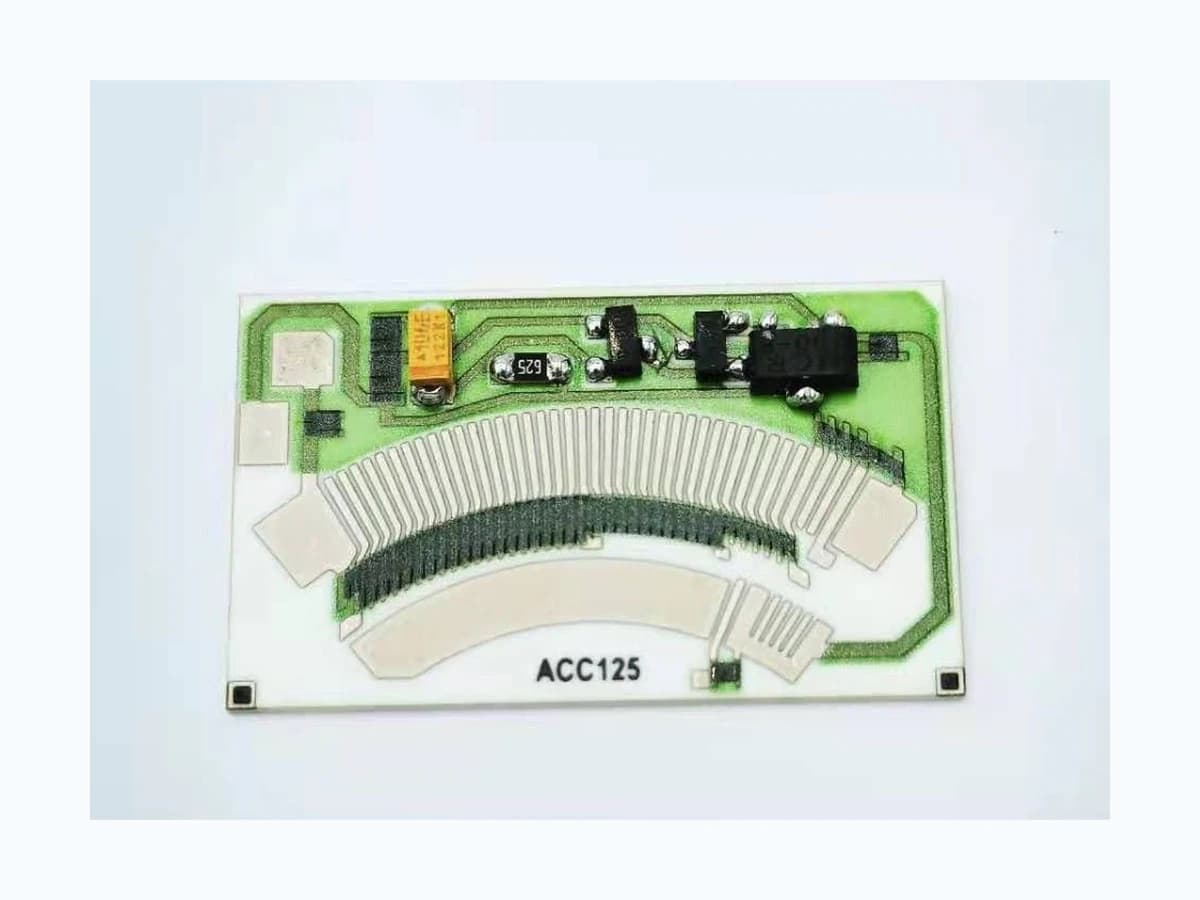 Real rotary-position resistor card with curved contact tracks, printed conductors, and mounted components