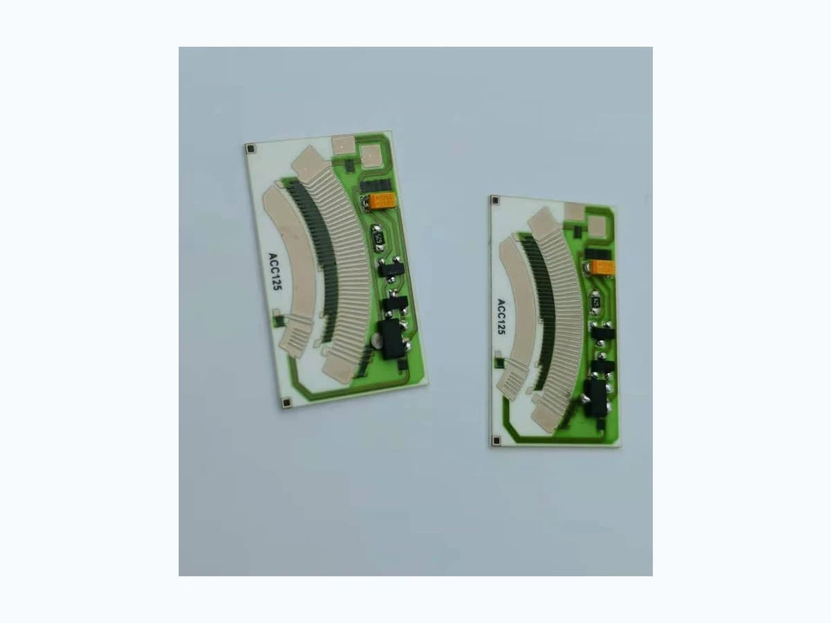 Real product photograph of a rotary position sensor resistor card with curved resistive tracks and connection pads