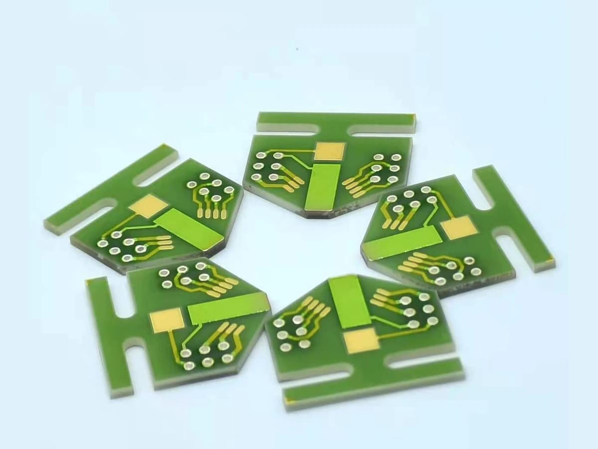 Group view of ceramic thick film circuit forms with repeated ringed apertures and printed routing