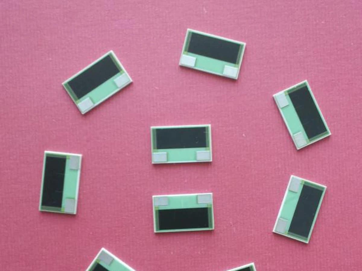 Controlled detail crop of a verified thick film power resistor showing the broad printed film and end terminals