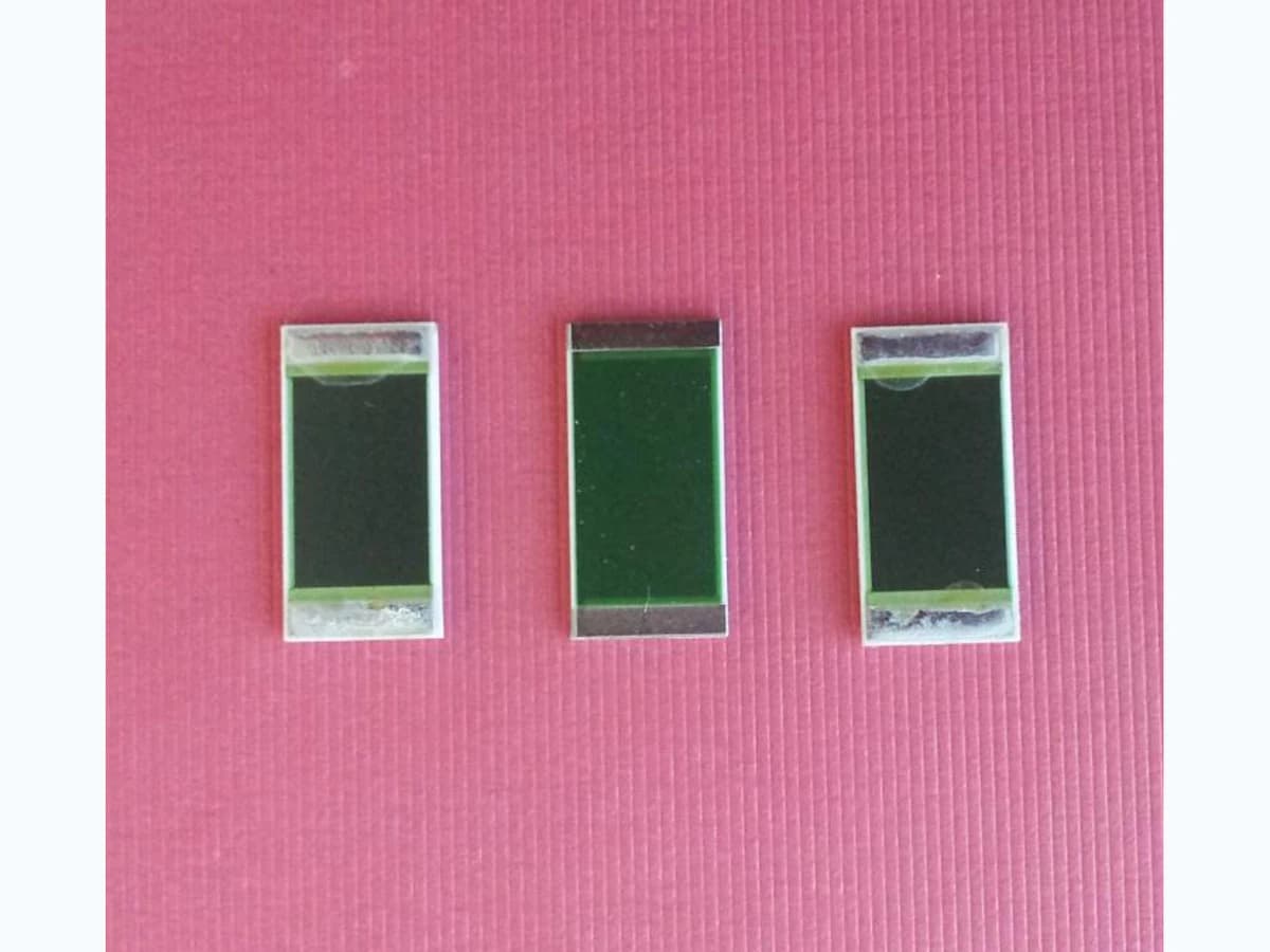 Product photograph of ceramic thick film power-resistor parts showing printed resistor zones and metallized terminals