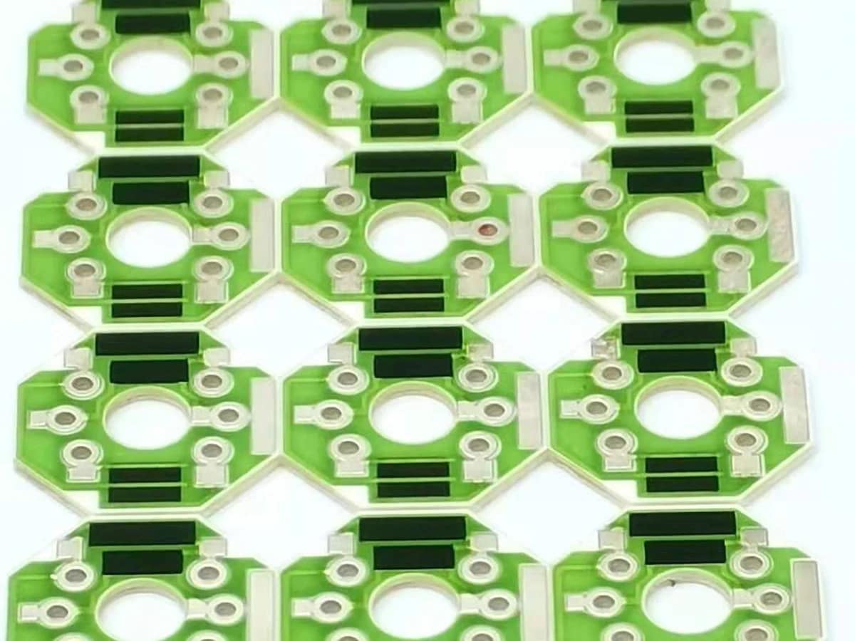 Controlled detail crop of a verified thick film voltage divider showing paired resistor films, conductor paths, and terminals