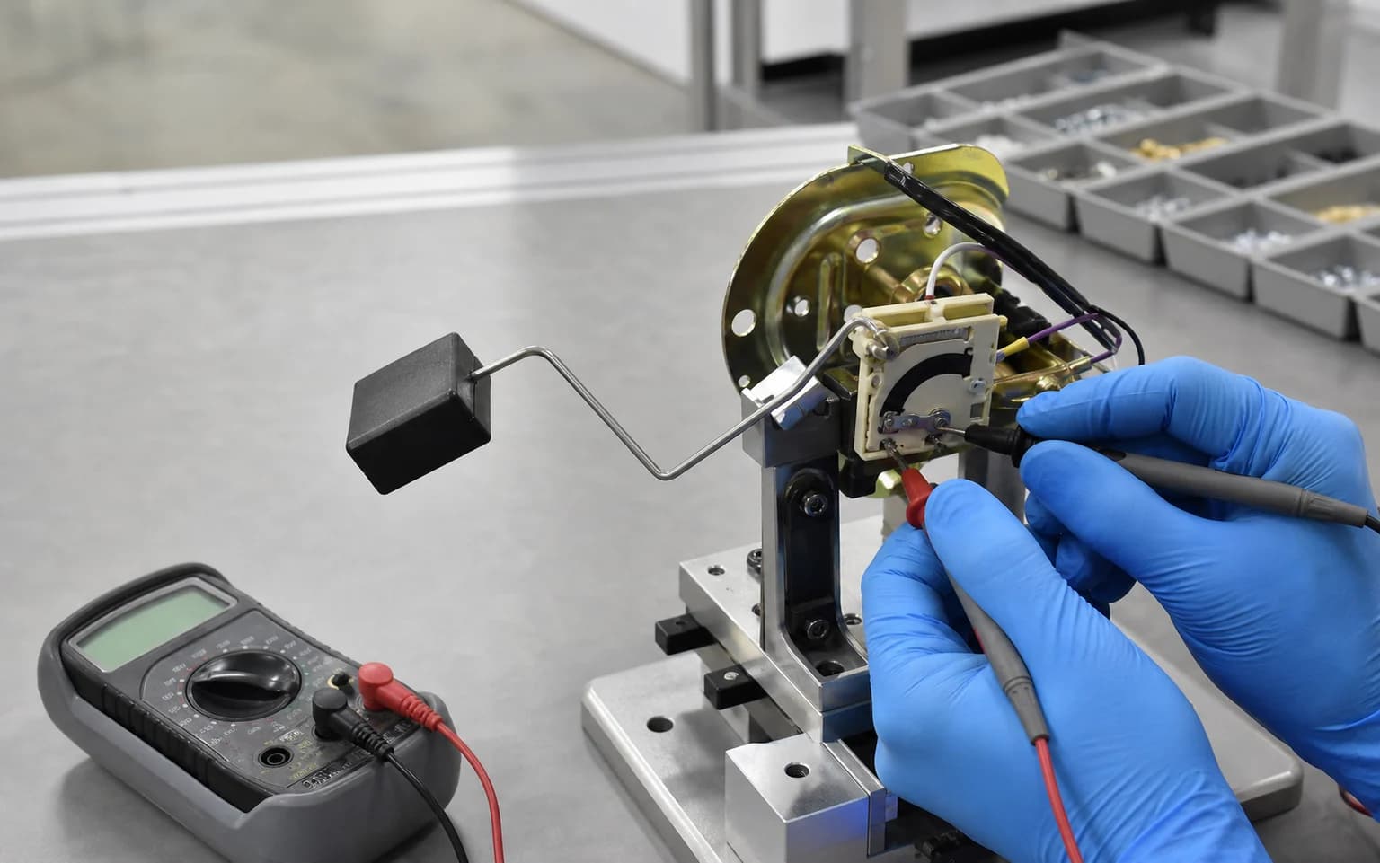 Automotive fuel sender with ceramic thick film resistor card being measured in a calibration fixture