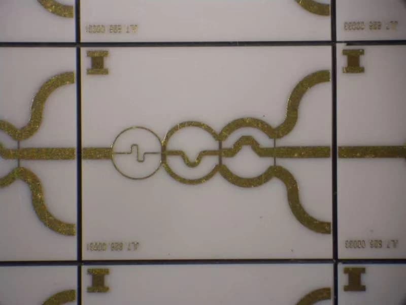 Company thin film circuit panel with connected curved patterns on a light substrate