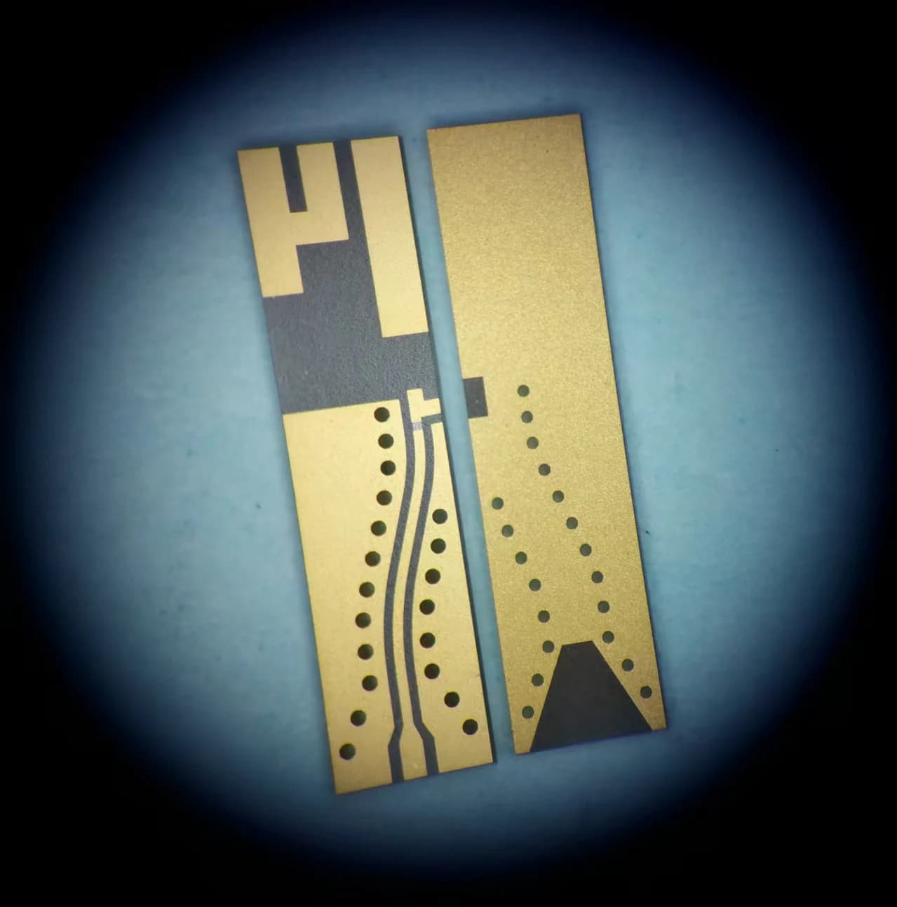 Company thin film circuit sample pair with fine patterned lines and rows of circular openings