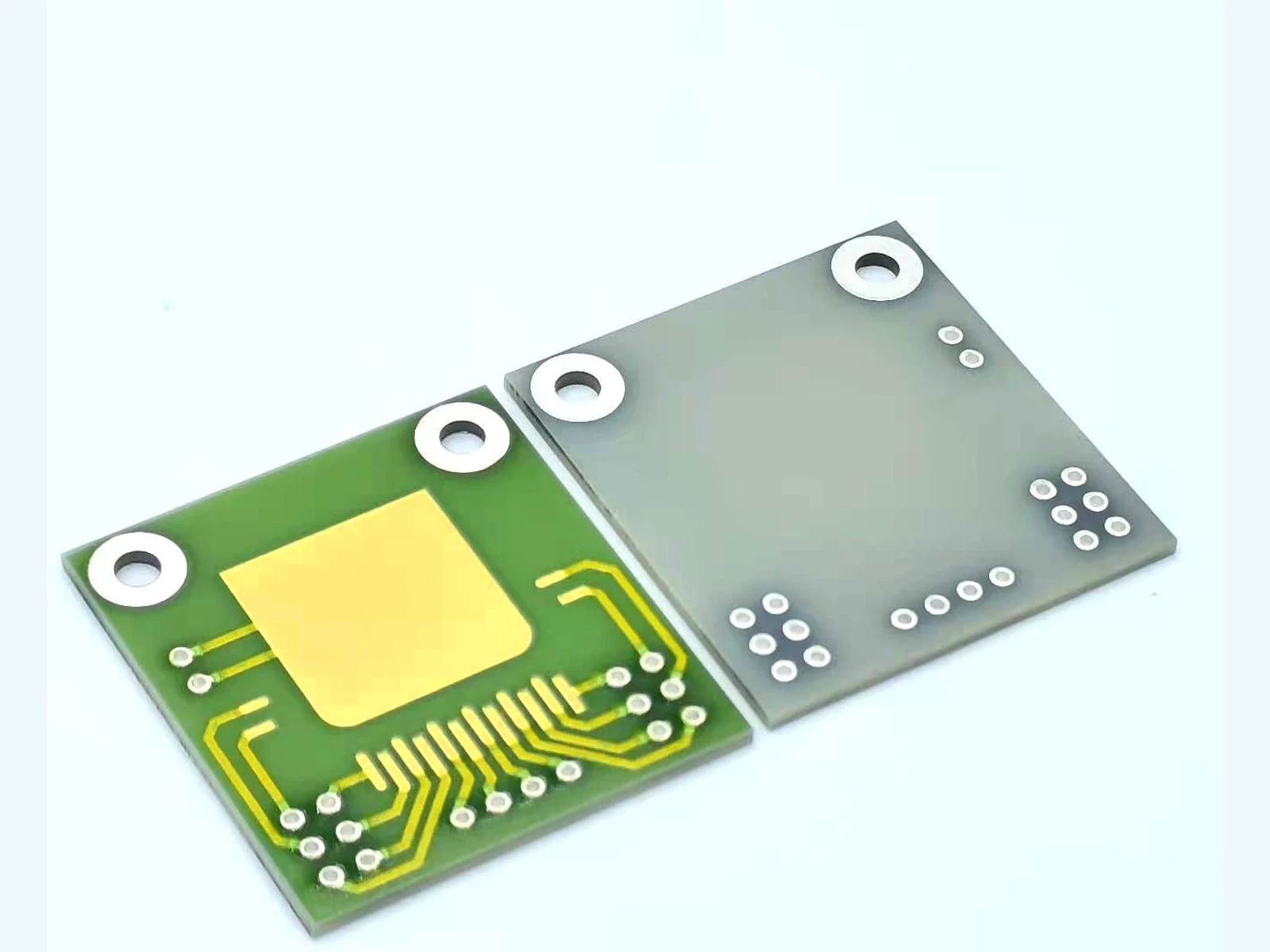 AlN thick film PCB front and rear product views with gold-colored routing and ringed openings