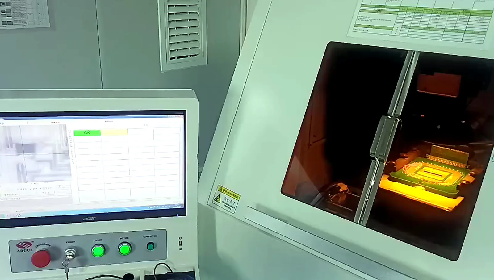 Company-supplied photograph of an enclosed laser trimming and electrical inspection station