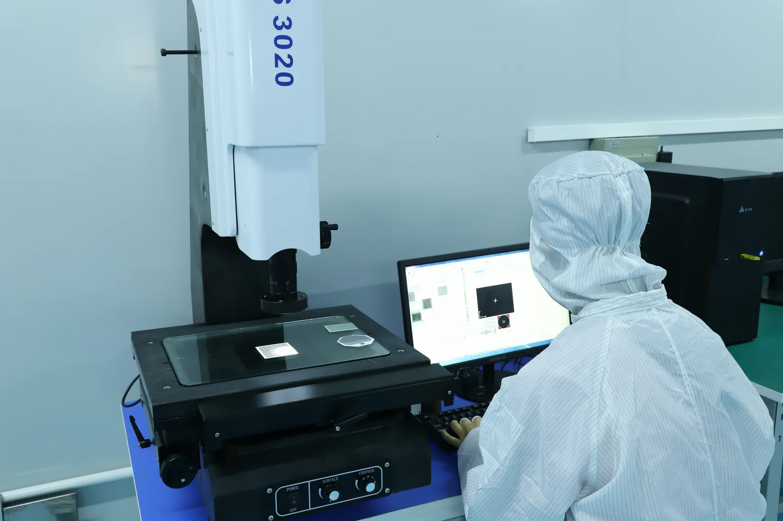 Company-supplied photograph of an operator using optical image measurement equipment