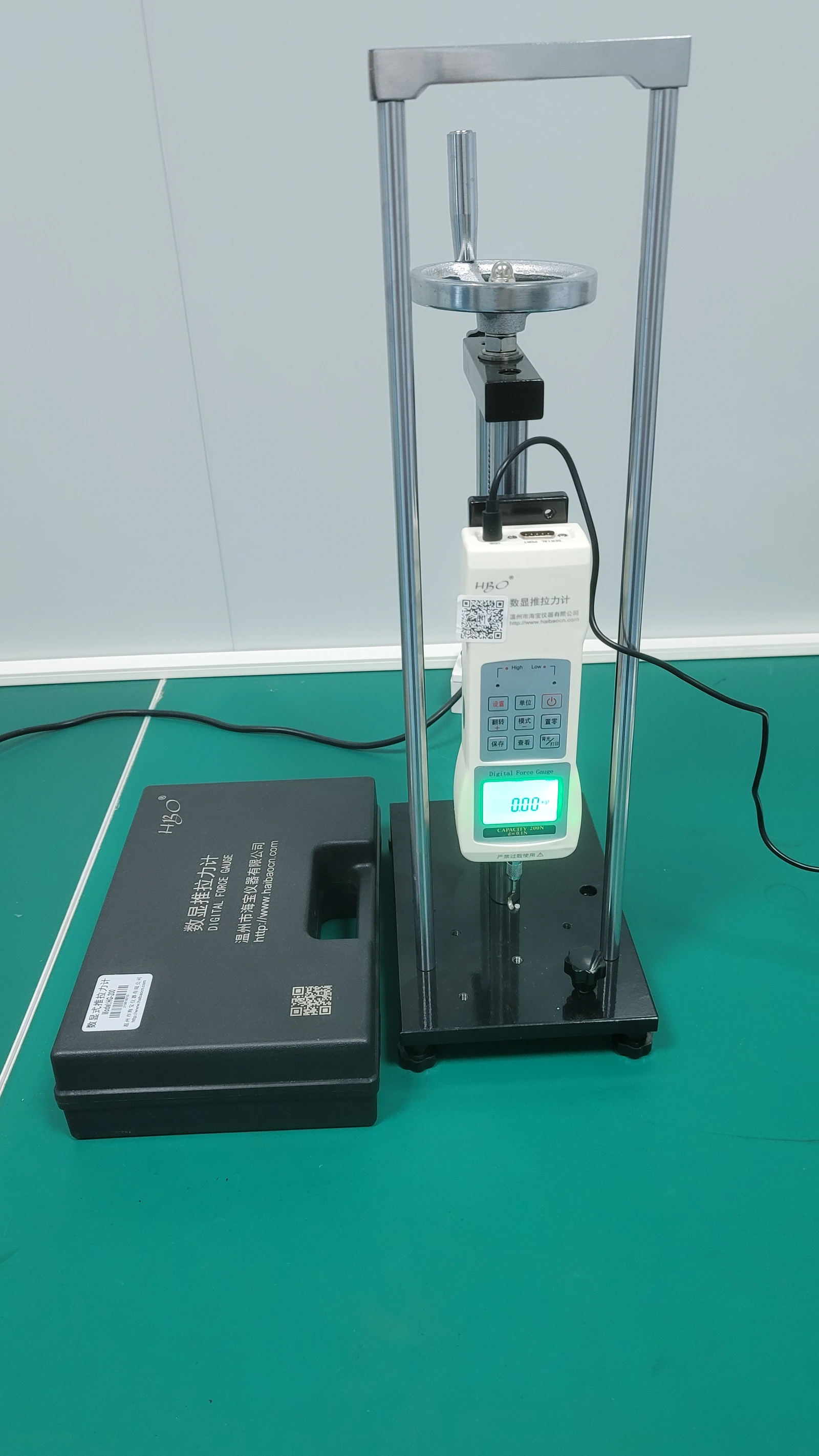 A mechanical force-test stand. Specimen attachment, loading direction and failure location define a useful adhesion test.