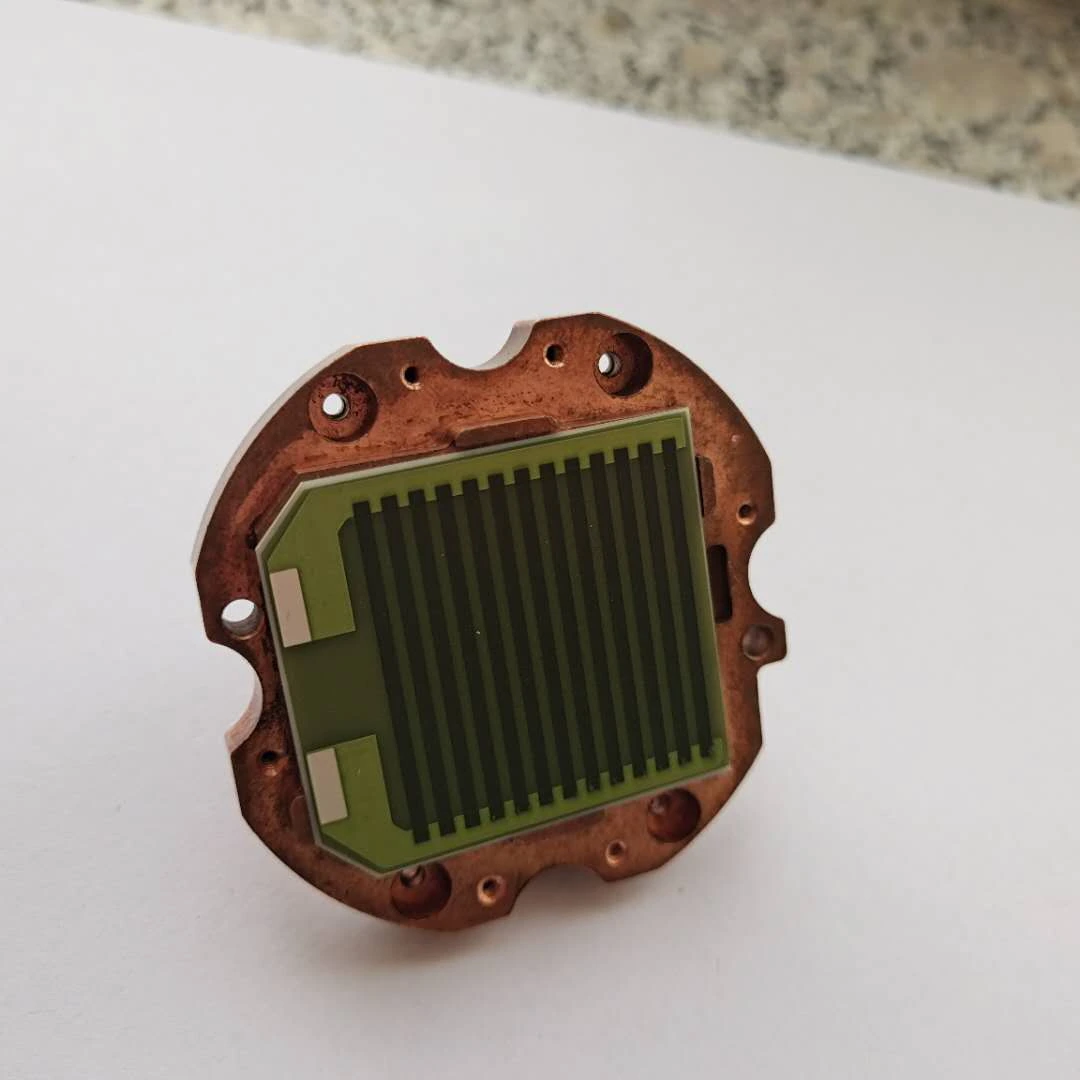 A coated resistive element seated in a metal fixture. Contact area and mounting interfaces sit between the circuit and its heat sink.