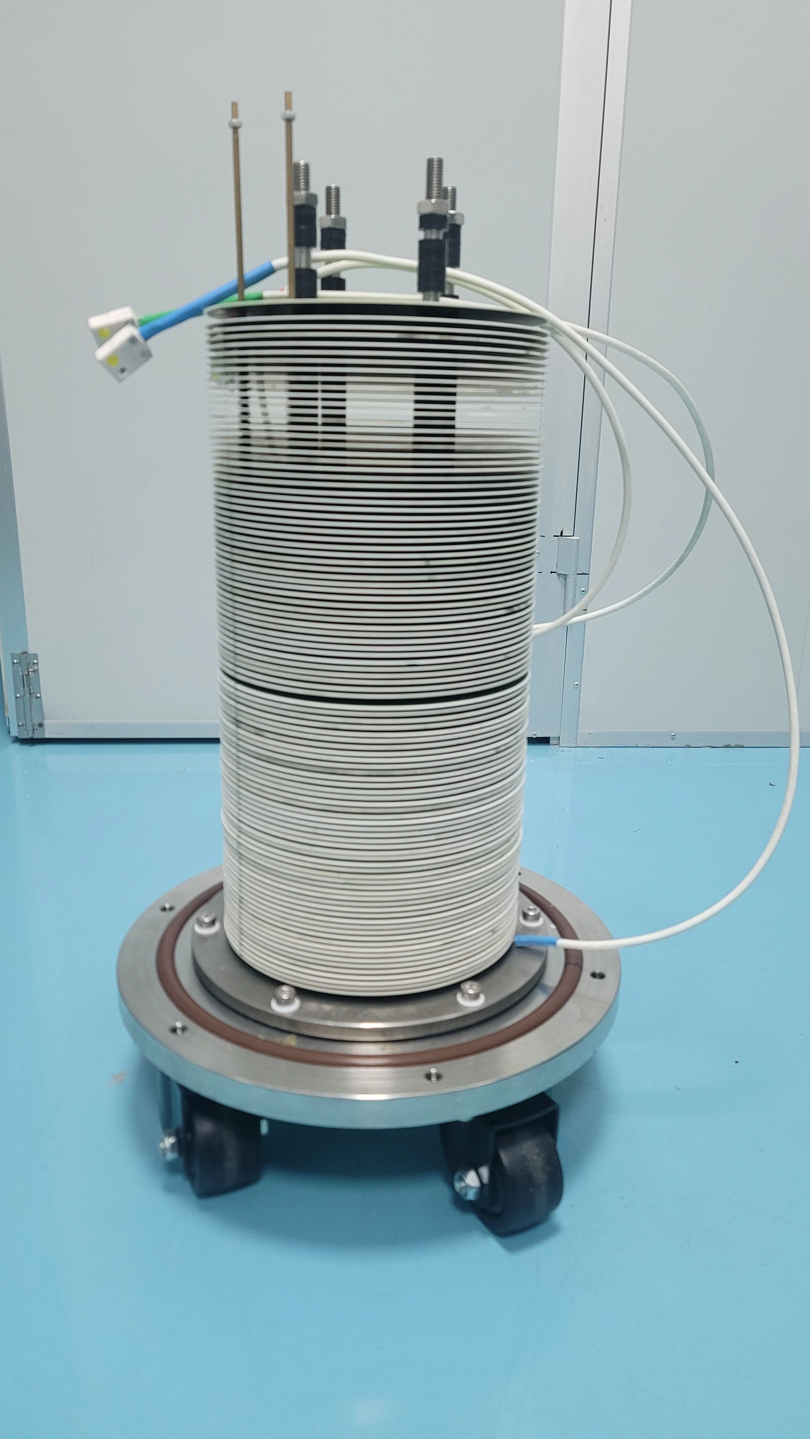 An assembled heating structure with fluid and electrical interfaces. Deposits add another layer to the heat-transfer path.