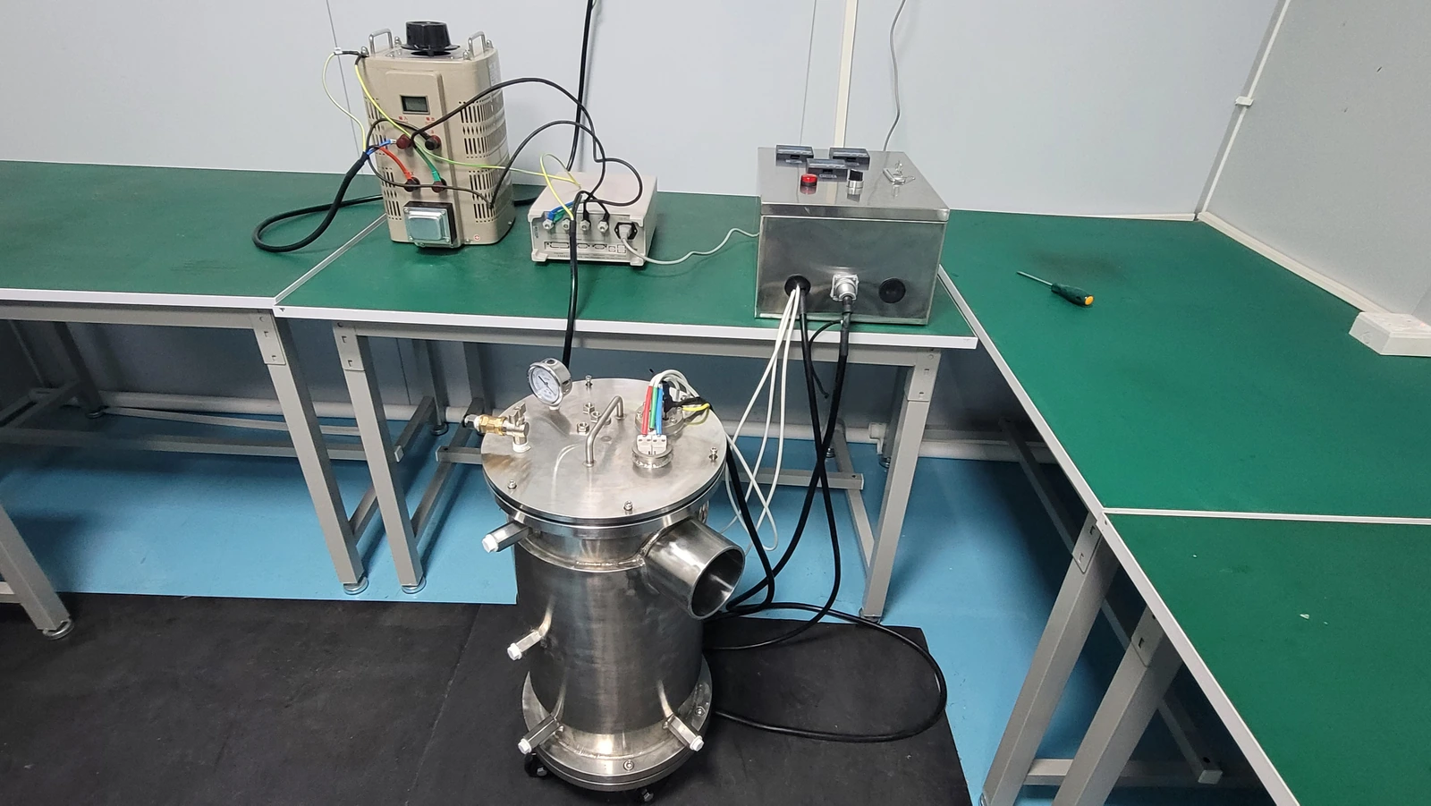 A fluid-heater test assembly and instrument wiring. A shutdown review needs the separate protection circuit and its measured response.