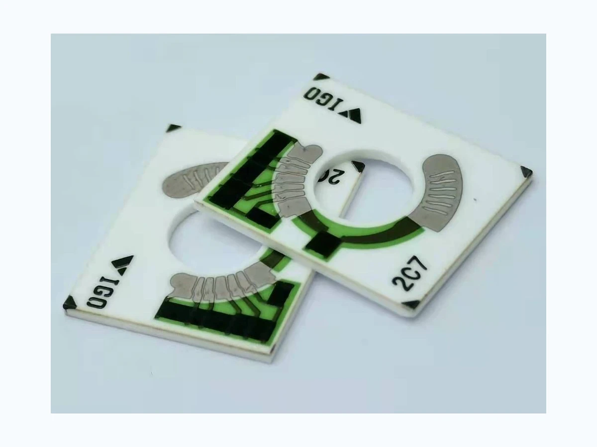 Curved contact tracks on fuel-level resistor cards. The mechanism translates liquid-level movement into track position.