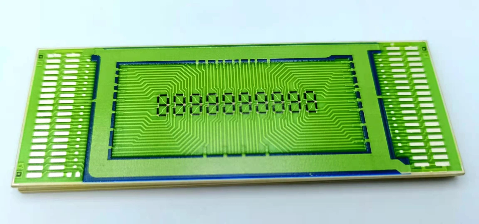 Wide ceramic circuit with green overglaze, numerous edge pads and fine routed conductor patterns.