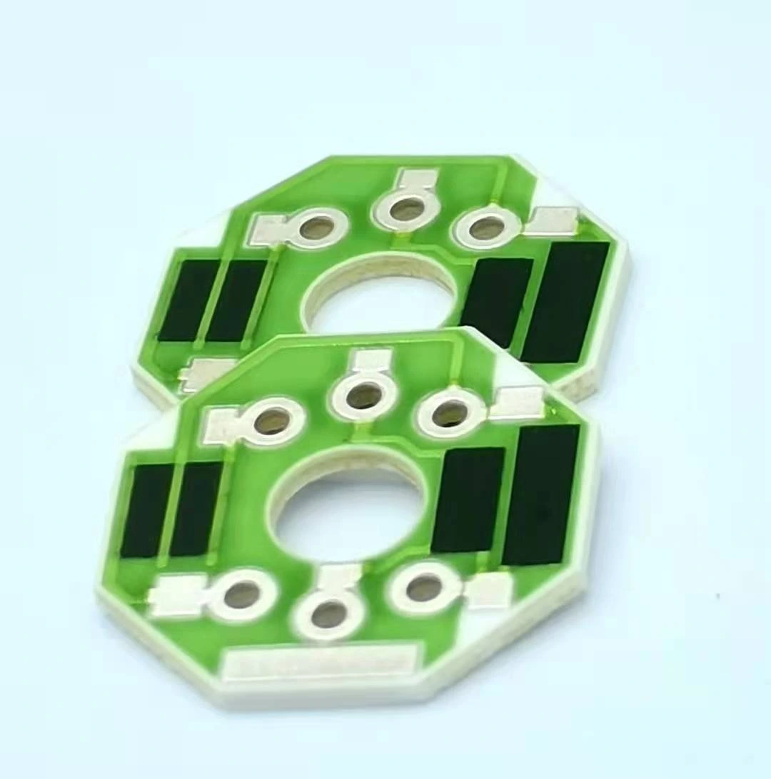 Two ceramic resistor units with central openings, four black resistive regions and exposed connection holes.