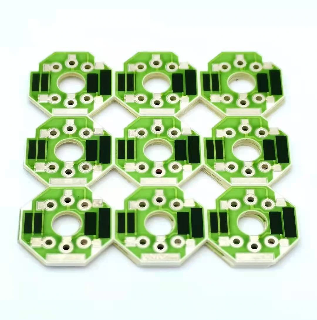 A panel of small ceramic resistor units with central apertures, green protective glass and exposed connection holes.