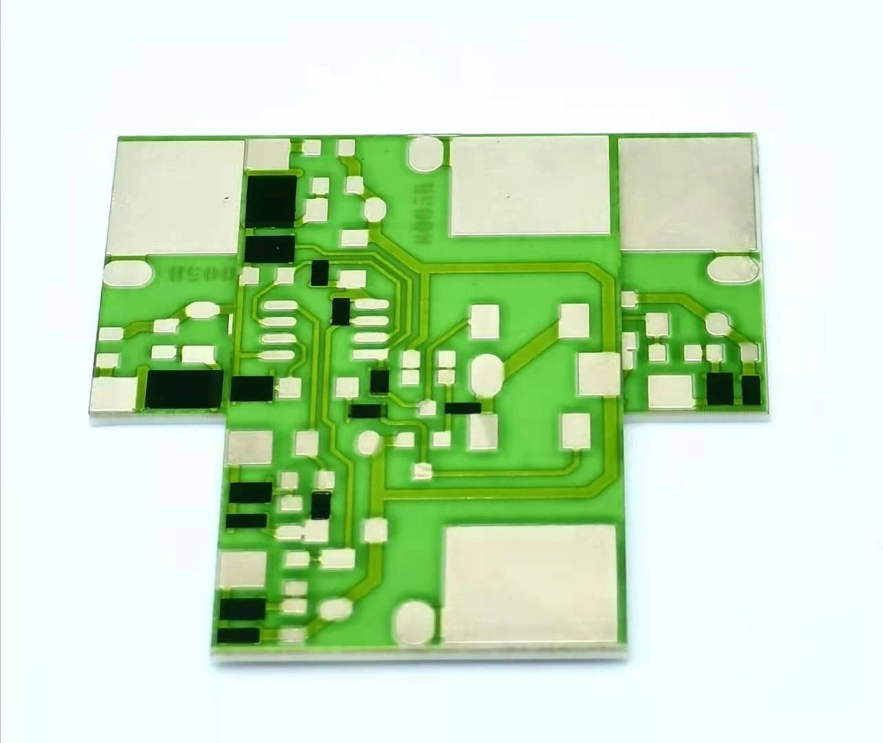 Three green-glazed ceramic circuit parts with patterned conductors, black resistor features and exposed metal regions.