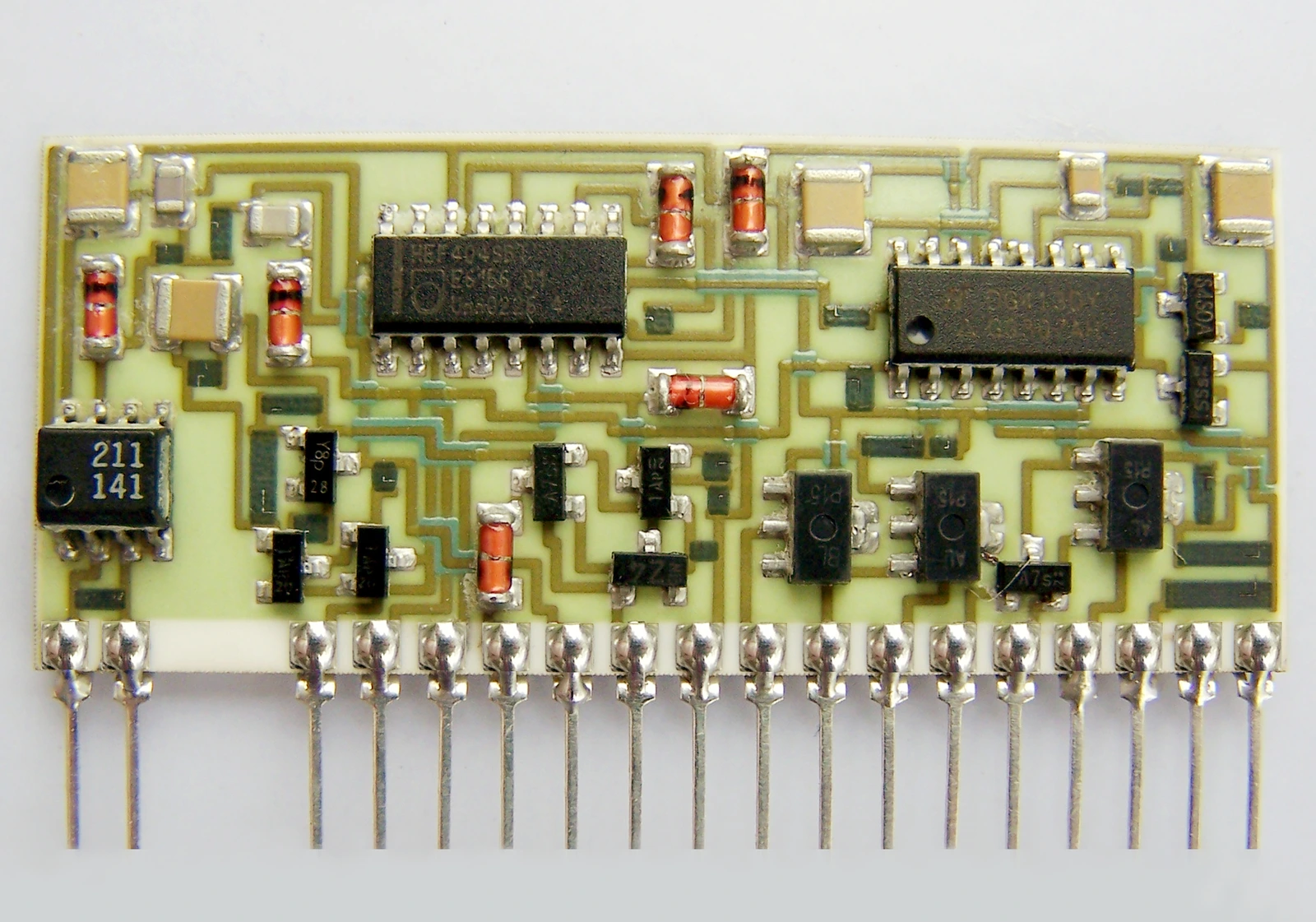 A populated ceramic hybrid circuit with attached components, patterned conductors and soldered external leads.