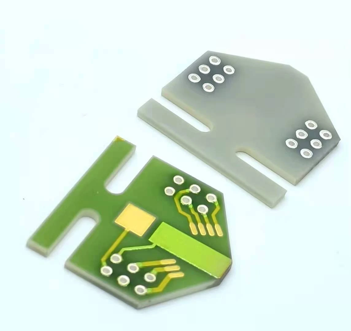 Front and reverse faces of a slotted ceramic circuit, with exposed contacts and mounting cut-outs.