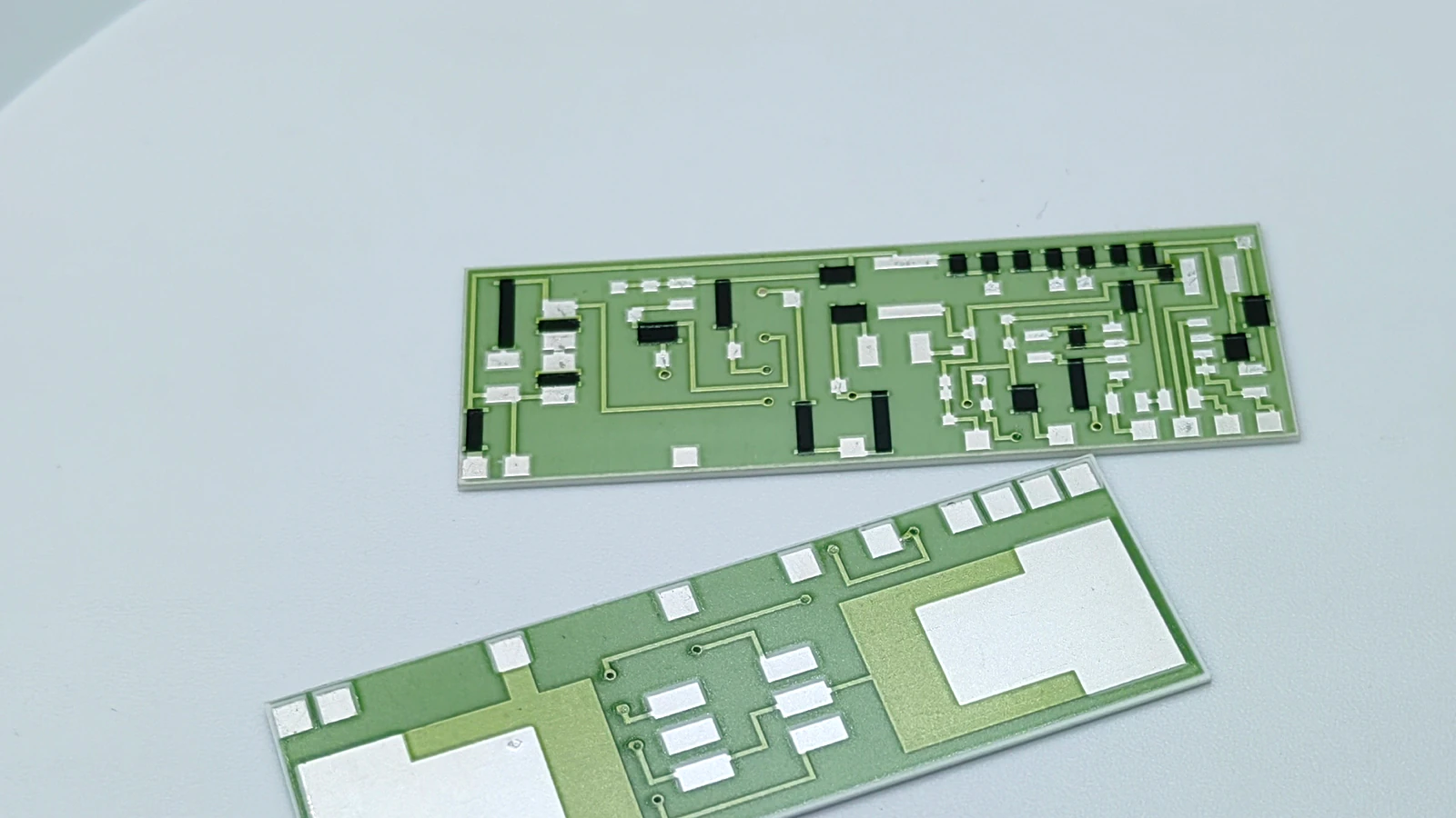 Real product view showing visible pads, routes, black blocks, and large terminal-looking areas on rectangular circuit forms