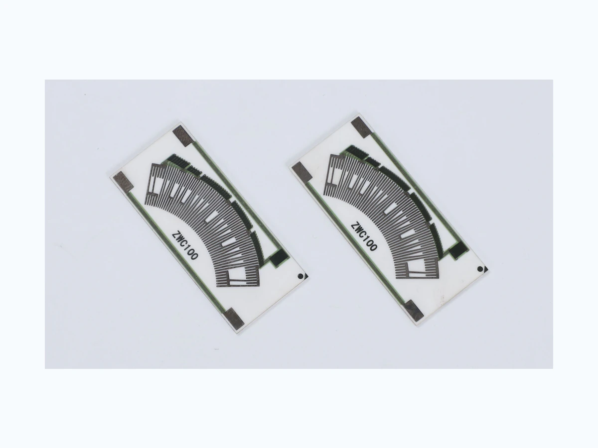 Two complete accelerator pedal position sensor resistor cards with printed arc tracks