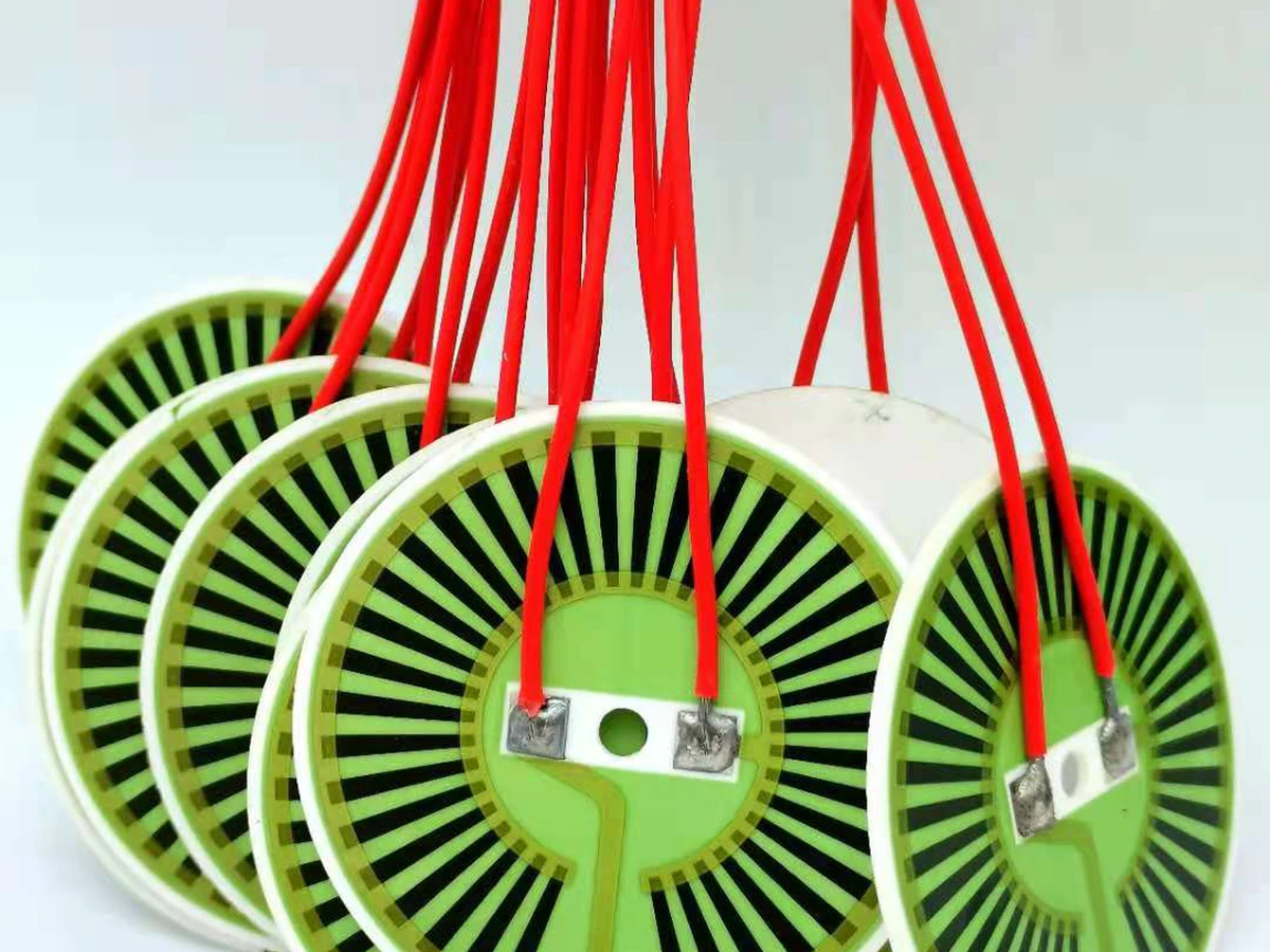 Detail of the visible alumina heater radial pattern, ceramic rim, and terminal region