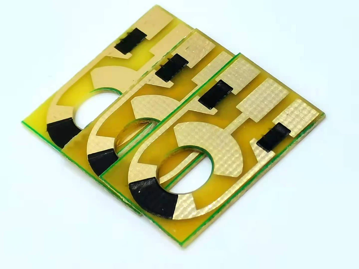 Carbon contact PCBs with gold-colored conductor areas, circular openings, and black printed contact sectors