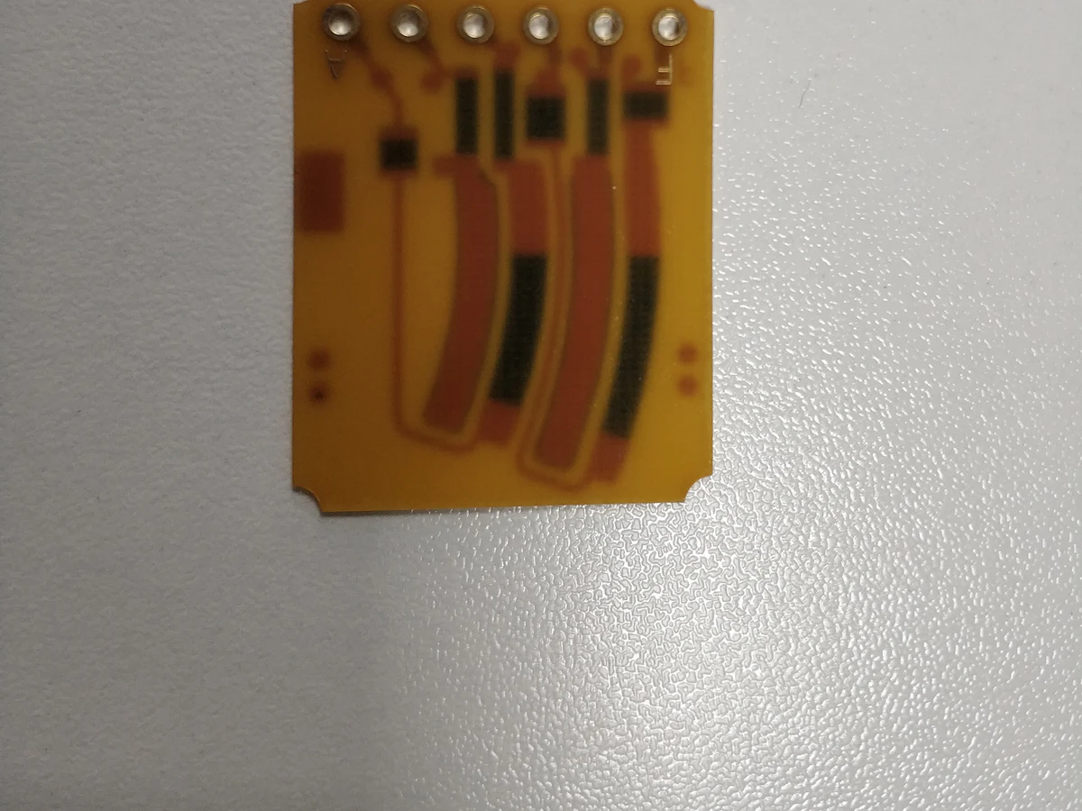 Controlled detail crop of a verified carbon ink jumper PCB showing black printed paths and conductor overlaps
