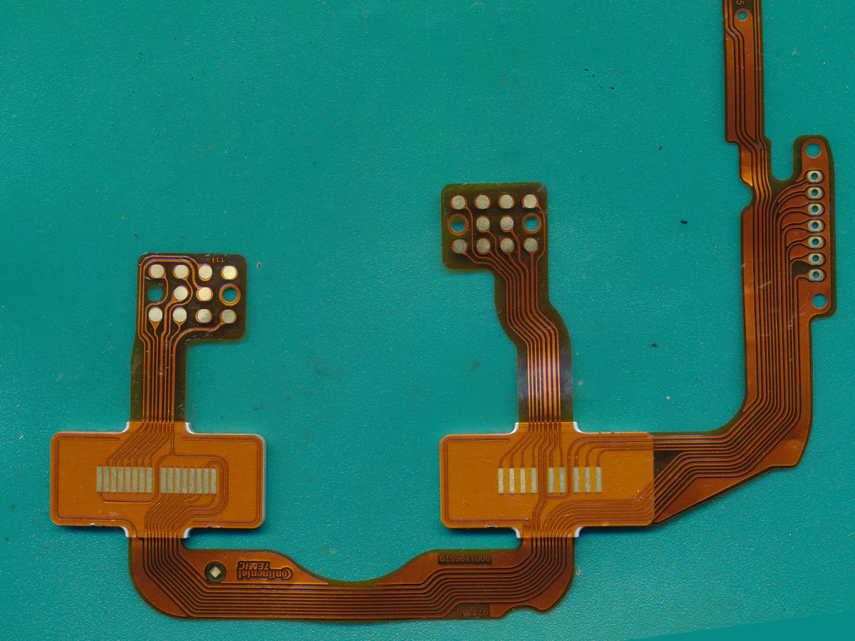 Controlled detail crop of a verified custom polymer thick film circuit showing flexible routing and terminal pads