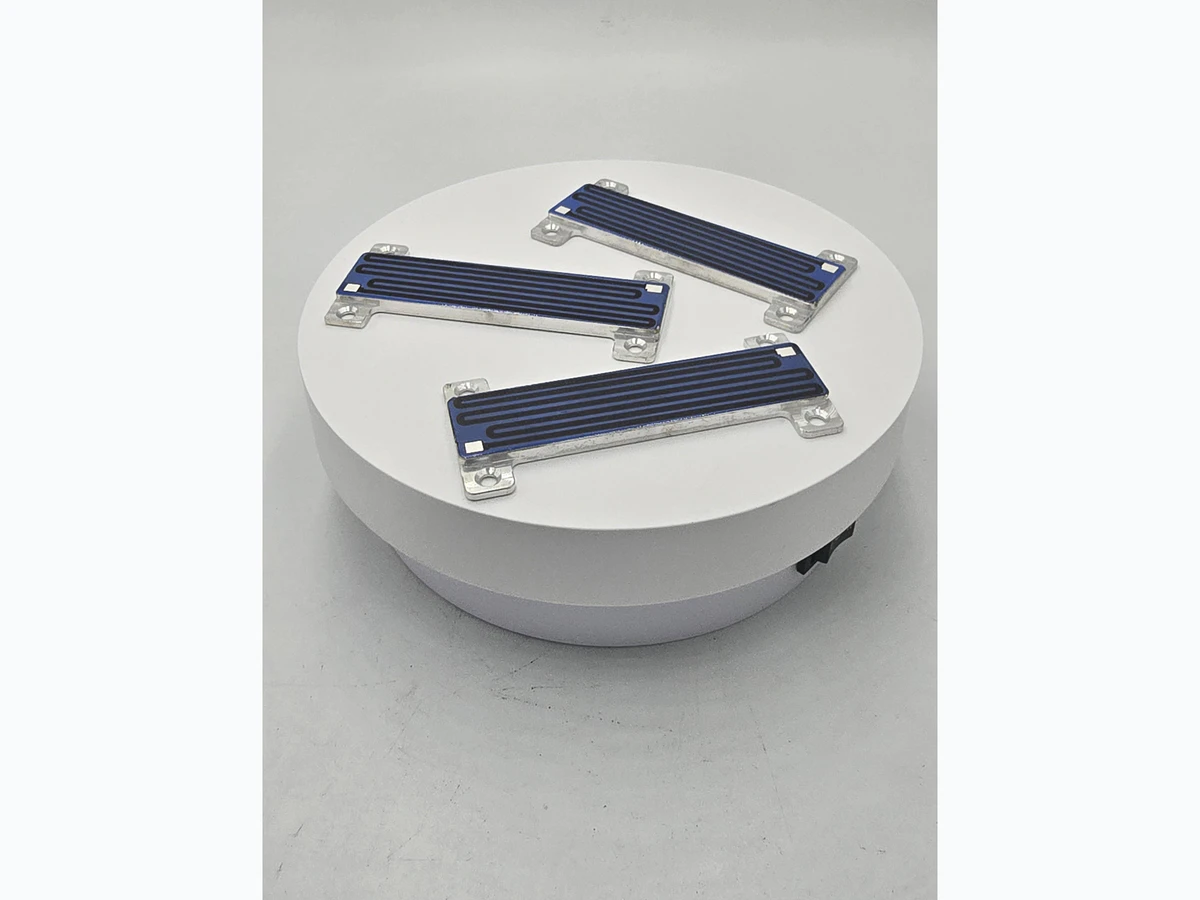 Supplied angled photograph of compact custom heater modules with visible printed paths and mounting features