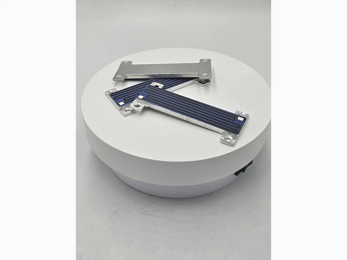 Supplied rear and edge photograph of compact custom-shaped heater modules