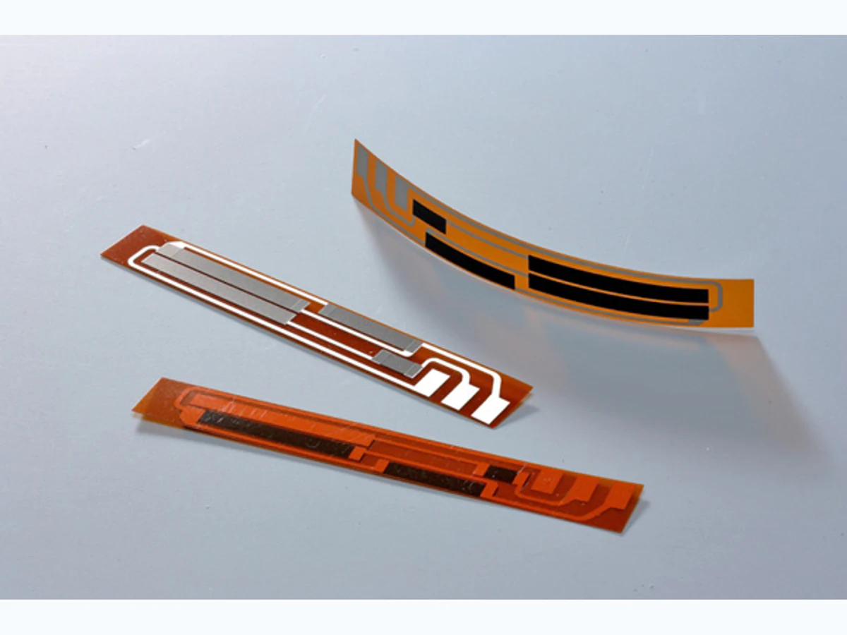 PI flexible position sensor samples showing straight and curved film strips with printed resistive and conductor tracks