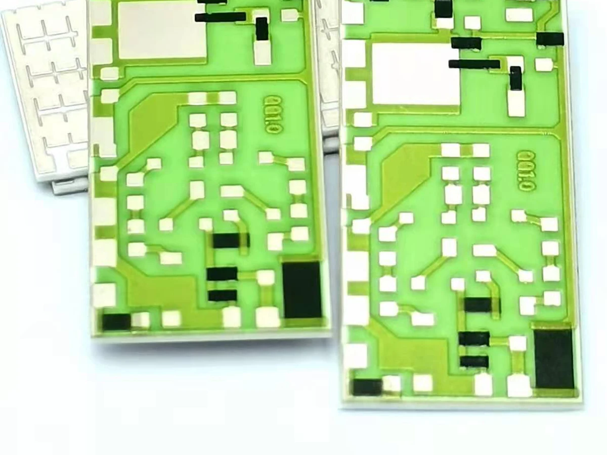 Controlled detail crop of a verified printed thick film resistor showing the resistor film, conductor overlap, and terminals